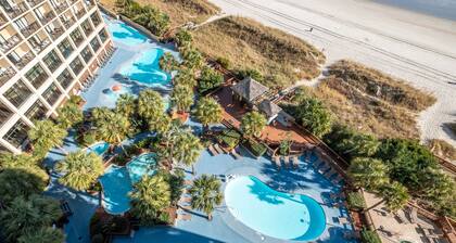 Condo moderne et propre en bord de mer avec piscines tropicales, bar tiki, piscine intérieure chauffée