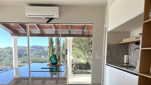 A modern kitchen with a view of a mountainous landscape.