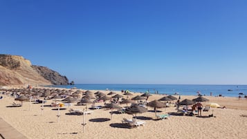 On the beach, sun-loungers
