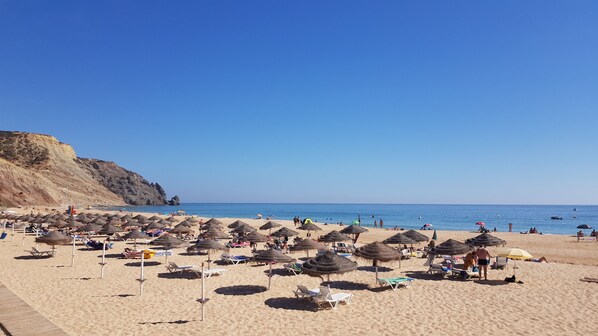 On the beach, sun-loungers