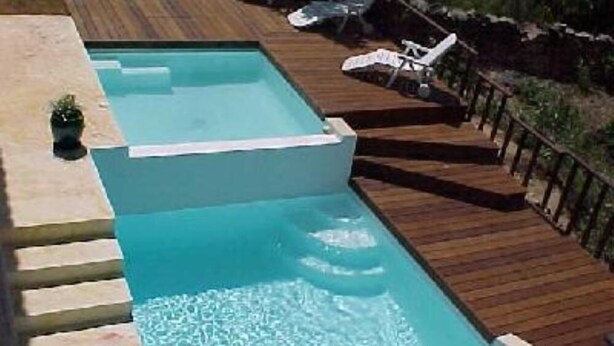 A rectangular swimming pool with a wooden deck and lounge chairs. - House / Villa - Porto vecchio (Porto-Vecchio)
