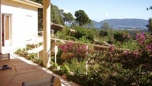 A covered outdoor area with a view of a mountainous landscape and a body of water. - House / Villa - Porto vecchio (Porto-Vecchio)