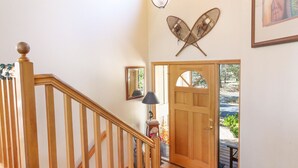 A staircase with wooden railings leading to a door with a glass panel. - Fort Rock-Wonderful Sunriver Home,3BR-3.5BA- Hot Tub- Wifi-8 SHARC passes (Sunriver)