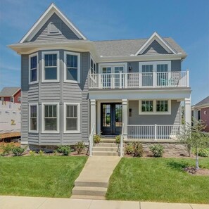 A two-story house with a front porch, a covered entryway, and a small front yard. - Notre Dame Ave. Dream Home Built in 2018 -1.5 Miles from Campus (South Bend)