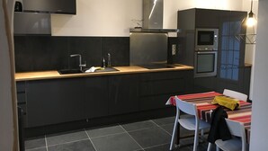 A modern kitchen with a built-in oven, microwave, and stainless steel appliances. - Family villa in Noirmoutier (175 m2, sleeps 11) (Noirmoutier)