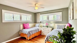 A bedroom with two beds, a ceiling fan, and large windows. - Five Star Home 2 miles from Biltmore Estate  (Asheville)