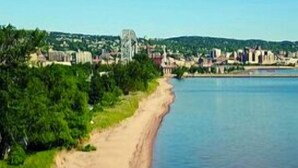 A coastal beach with a sandy shore and a calm sea. - Minnesota Point Beach House 1-Spectacular Lake Superior View (Duluth)