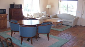 A living room with a dining table, chairs, a sofa, and a television. - Lupine Ranch - Wine Country Guest House (Templeton)