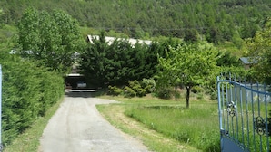 A rural road leading to a tunnel with a vehicle inside. - Apartment in a quiet village (Briançon)
