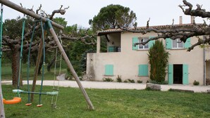 A house with a swing set in a grassy yard. - Separate gite without immediate neighbour on laid out field, a lot of space... (Les Granges-Gontardes)