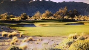 A golf course with a water hazard, trees, and mountains in the background. - Your Perfect Getaway Awaits- Ideal for Students and Families (Chandler)