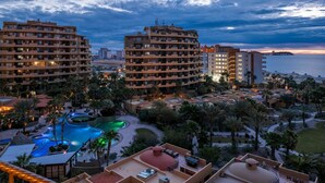 A resort with multiple buildings, a swimming pool, and palm trees. - Gorgeous Ocean View- completely remodeled 2/2, Great Decor, Fireplace, King Beds (Puerto Penasco)
