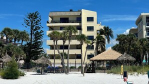 A beachfront hotel with multiple floors, palm trees, and thatched umbrellas. - Crescent Beach Escape – 2BR Beachfront Condo on Siesta Key
Steps to the sand! (Siesta Key)