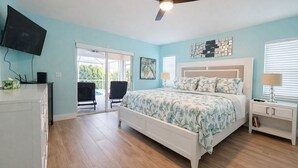 A bedroom with a bed, a ceiling fan, a TV, a desk, and a chair. - True Happiness In Paradise!  Close To Everything!  Heated Pool! (Marco Island)