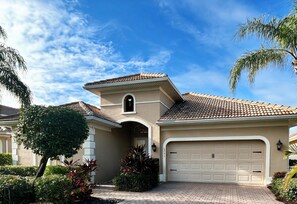 A residential house with a garage, a small tower-like structure, and a well-maintained garden. - Private Cabana Villa Luxury 3BR - 3BA Mustang Golf Course at Lely Resort, Naples (Naples)
