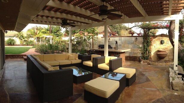An outdoor patio with wicker furniture, a stone fireplace, and a pergola. - Private Guest Unit with backyard, Home away from home! (Santa Ana)