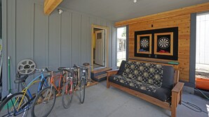 A room with a wooden bench, a bicycle, and a door leading outside. - Fun Guest Quarter With Bathroom Available For Rent Close To Downtown Bend. (Bend)
