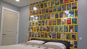 A bedroom with a bed, a ceiling fan, and a wall covered with posters. - Fun Guest Quarter With Bathroom Available For Rent Close To Downtown Bend. (Bend)