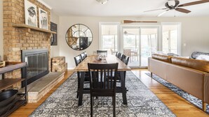 A spacious living area with a fireplace, dining table, and seating. - NASH Lakehouse 5 bedroom 30 mins to downtown  (Mount Juliet)