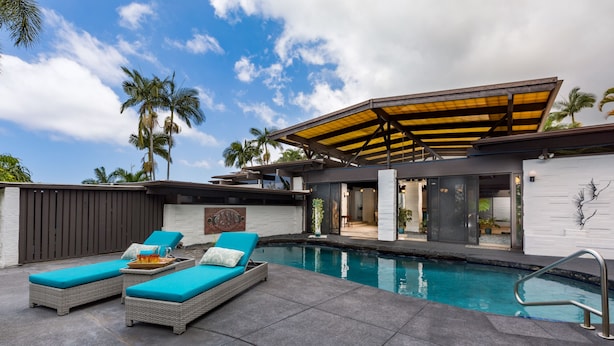A modern outdoor pool area with two lounge chairs and a covered seating area. - Private Oceanview Oasis w/Pool, Spacious Lanai, & Stunning Sunsets: Ono Oasis (Kailua Kona)