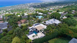 An aerial view of a residential area with houses, a swimming pool, and a view of the ocean. - Private Oceanview Oasis w/Pool, Spacious Lanai, & Stunning Sunsets: Ono Oasis (Kailua Kona)
