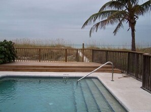 Heated beachside pool with deck overlooking the beach