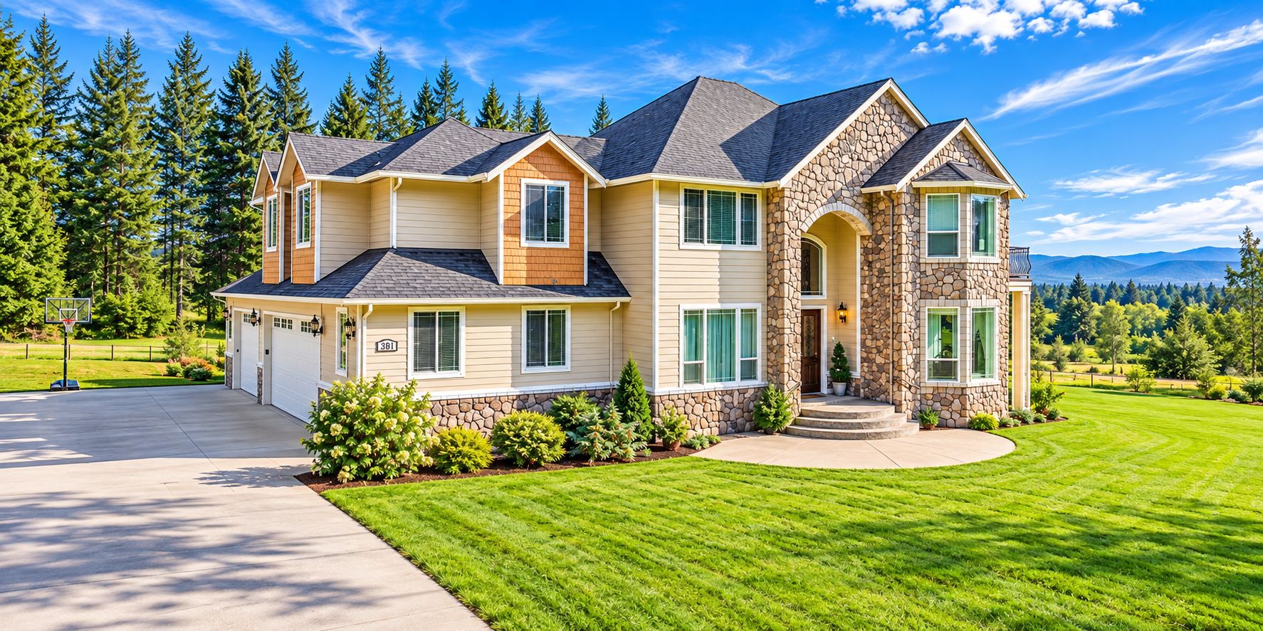 A two-story house with a stone facade, a driveway, and a well-maintained lawn.