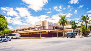A multi-story building with a flat roof and a yellow and brown facade. - Coyotes Hotel and Conference Centre (Mbombela)