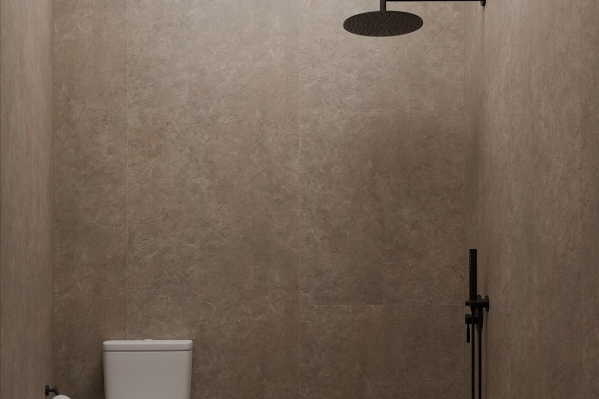 A small, modern bathroom with a toilet, a shower, and a toilet paper holder.