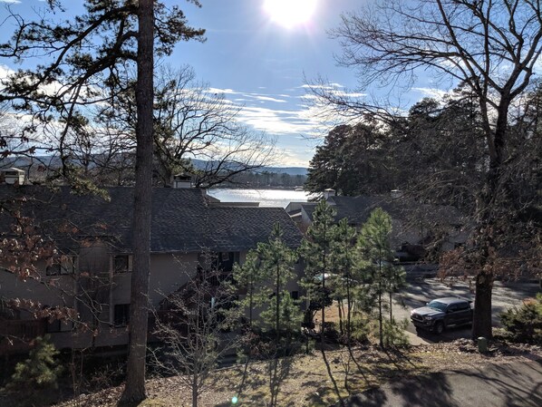 A residential area with houses, trees, and a clear sky.