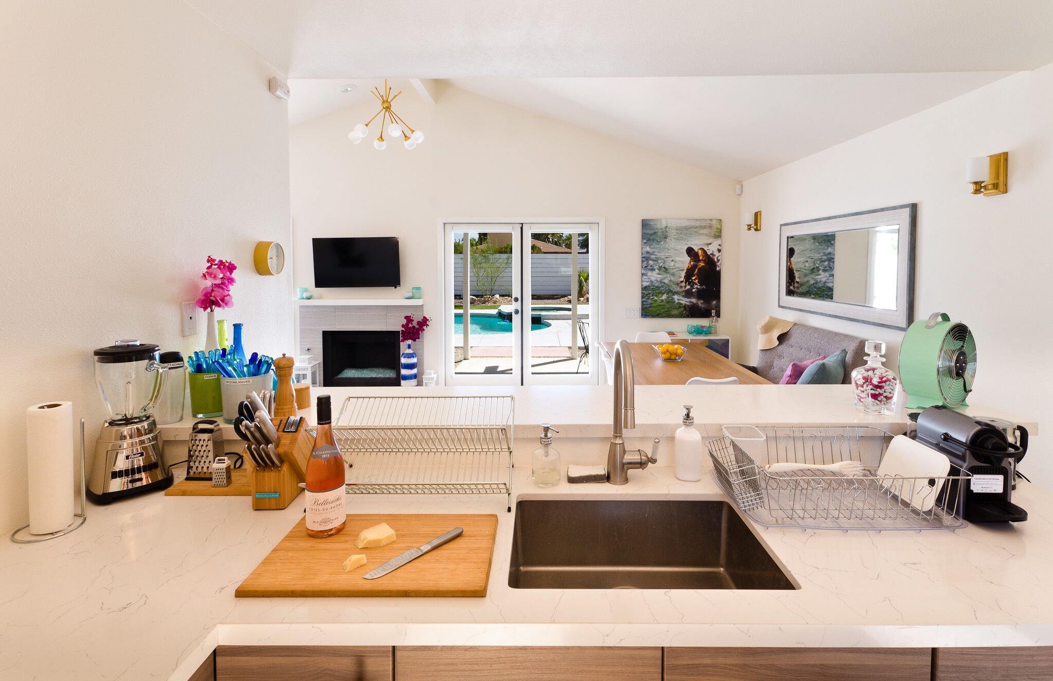 Kitchen looks over to the living area and pool