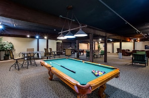 Relax in our indoor recreational area, featuring a pool table and comfortable seating options.