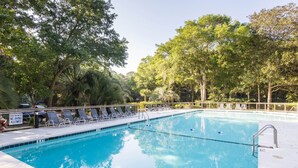 A swimming pool with lounge chairs and a sign indicating shallow water and no diving allowed. - Pet-Friendly 3BR Inlet Cove Cottage - Walk to Beach, Pool & Kiawah River (Johns Island)