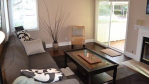 A living room with a sofa, armchair, and coffee table. - Beach Walk to Salt Creek Beach for Surf and Sun - Air Conditioned STR15-0392 (Dana Point)
