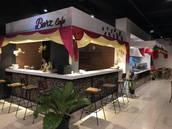 A restaurant named 'Brix Cafe' with a bar area, seating, and a kitchen visible. - Burza Hotel (Lubuklinggau)
