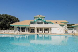 A swimming pool with a building in the background.
