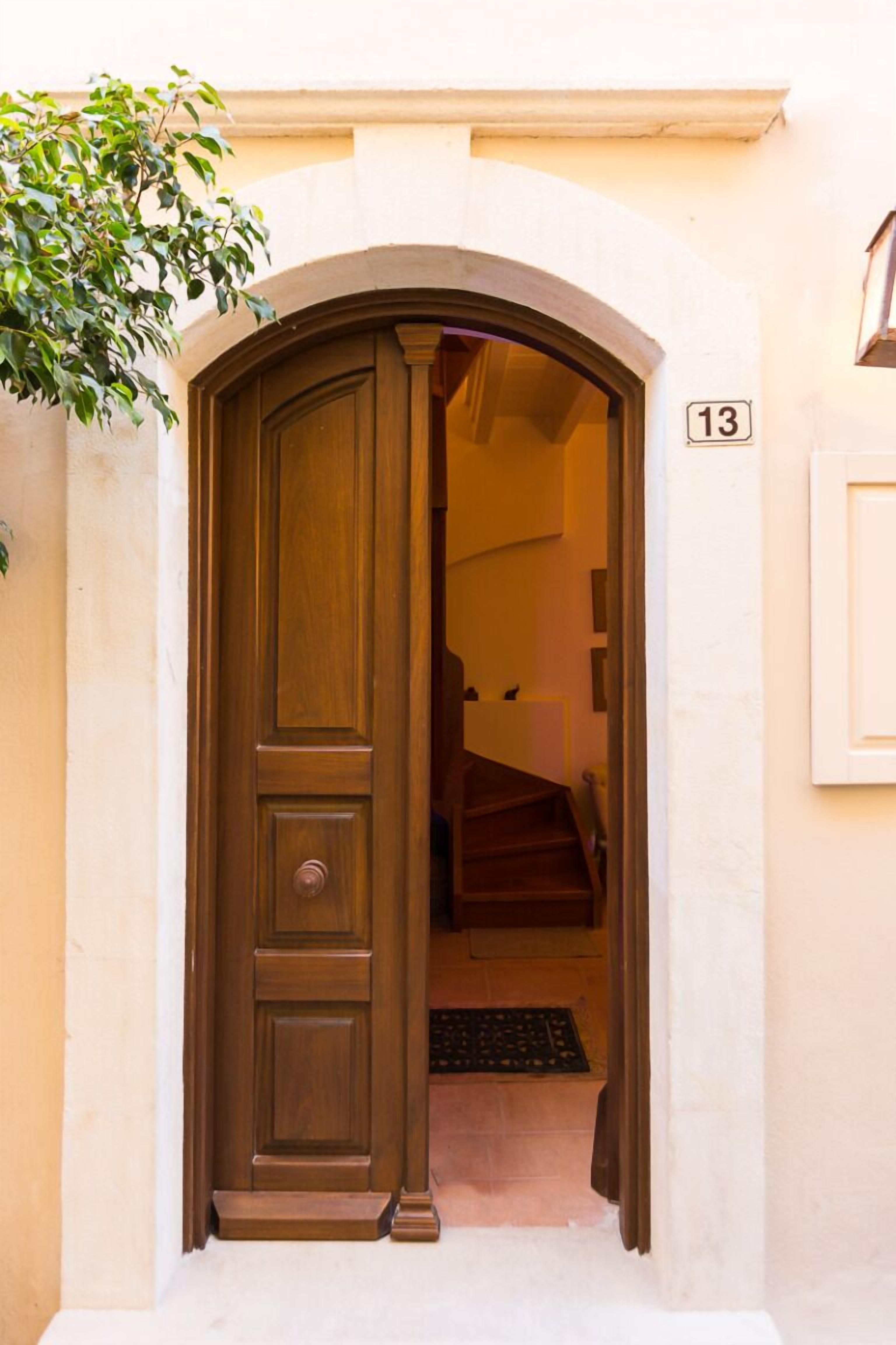 A wooden door with a number 13 on the wall above it.