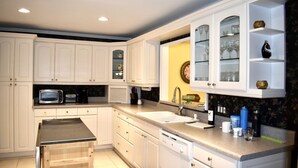 A modern kitchen with white cabinetry, a built-in oven, a sink, and a countertop with various items. - Spacious Villa Lovely golf course view Free Tennis-PB! 20% Aug 29! (Hilton Head Island)