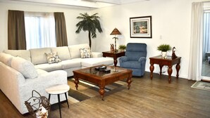 A living room with a sofa, armchair, coffee table, and side tables. - Spacious Villa Lovely golf course view Free Tennis-PB! 20% Aug 29! (Hilton Head Island)