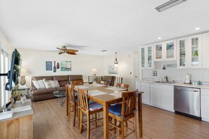 A compact living space with a dining area, kitchen, and seating area. - Coastal Cottage with community pool, free parking and boardwalk to beach- SCV 12 (St Augustine Beach)