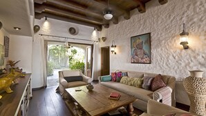 A cozy living room with a wooden coffee table, a sofa, and a decorative vase.