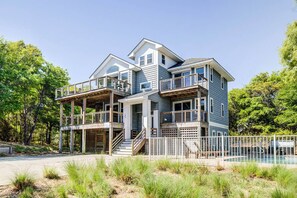 A two-story house with a balcony and a pool. - OBX Dream (House) | 1920 ft from the Beach | Private Pool | Southern Shores (Southern Shores)