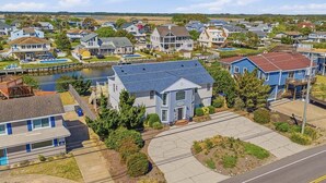 A residential area with houses, a dock, and a clear sky. - Sandpiper Crossing | 555 ft from the beach | Private Pool, Hot Tub (Virginia Beach)