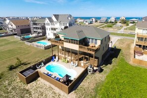 Enjoy a rooftop pool and barbecue on this two-story home's expansive deck.