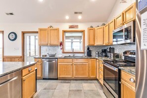 Fully equipped kitchen with double sink, stove, and refrigerator.