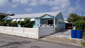 A two-story house with a blue exterior and a white fence. - 2 minute Walk to Beach, Newly Renovated, 2 Bed 2 Bath Apartment #1
Shenstone (Rockley)