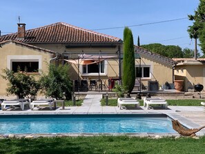 Enjoy a refreshing dip in the pool surrounded by lounge chairs and a barbecue grill.