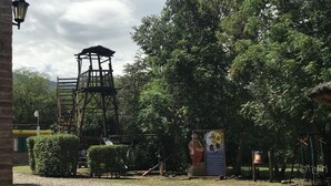 A playground with a wooden climbing structure and a mural. - Sol y Luna (Los Molles)