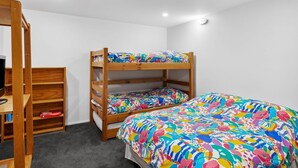 A bunk bed with colorful bedding, a wooden bookshelf, and a skylight. - Maddlyn with  Ocean Views & Peaceful Treed Retreat (Lorne)