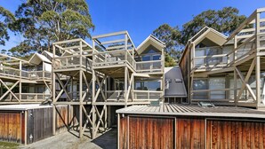 A multi-level wooden structure with balconies, surrounded by trees. - Maddlyn with  Ocean Views & Peaceful Treed Retreat (Lorne)